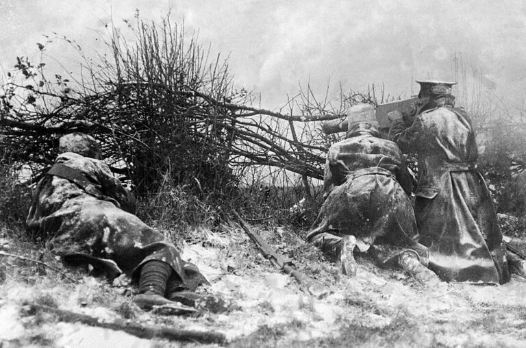 British Soldiers Firing A Machine Gun From Behind A Hedge In The Snow. 7th December 1914.